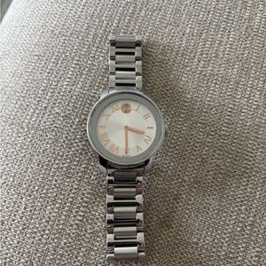 Movado Silver Timepiece with White Face and Gold Accents